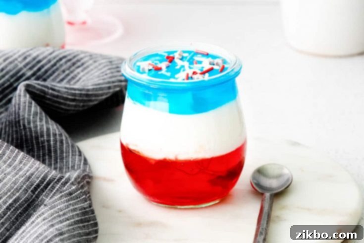 Individual 4th of July Jello Cups, layered with red, white, and blue, offering a festive single-serve dessert option.