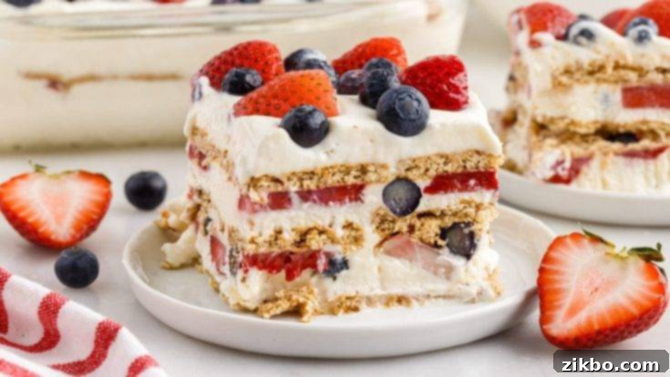 A refreshing Mixed Berry Icebox Cake, featuring layers of graham crackers, fluffy cream, and fresh red and blue berries, perfect for summer.