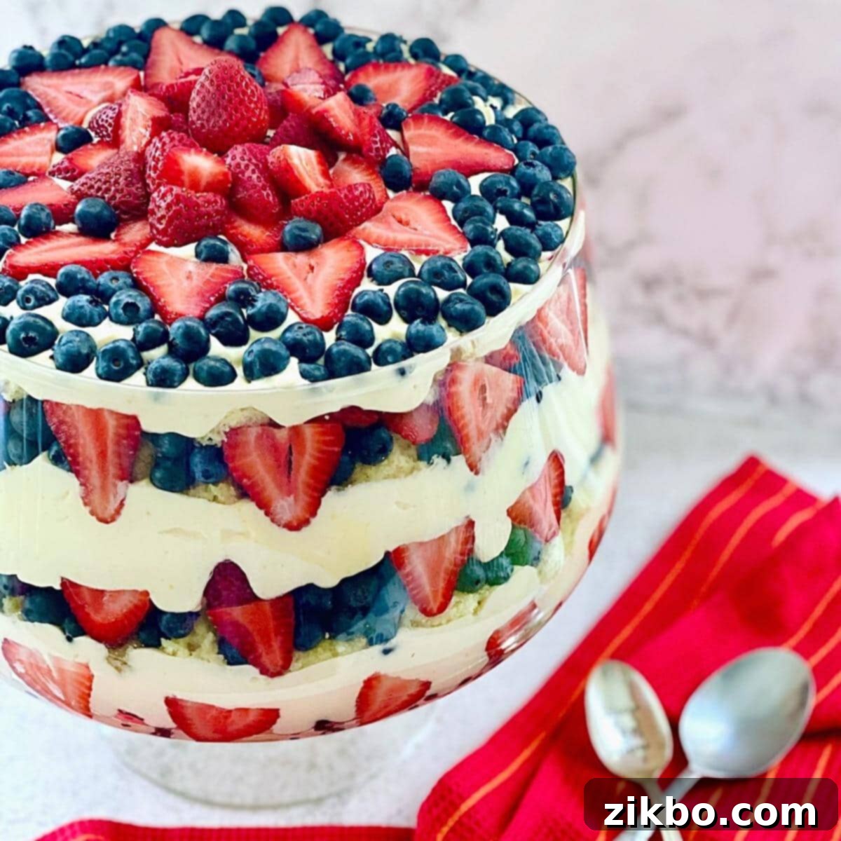 A stunning Patriotic Berry Trifle, layered with fresh red and blue berries, creamy pudding, and fluffy pound cake cubes.