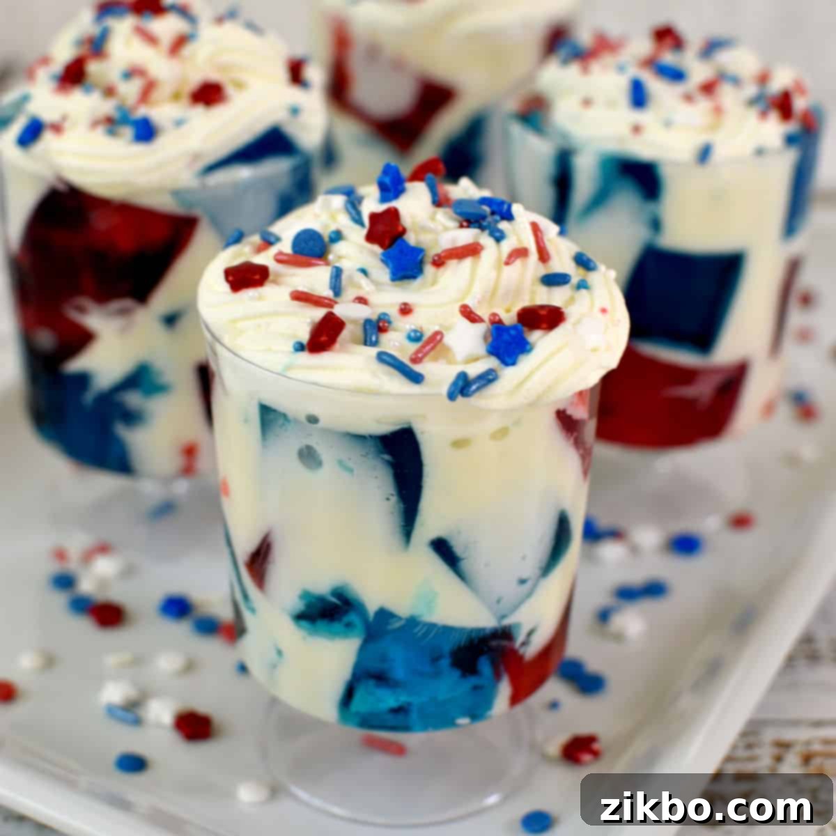 Make-ahead Red, White, and Blue Jello with Cream, layered for a beautiful and delicious patriotic dessert.