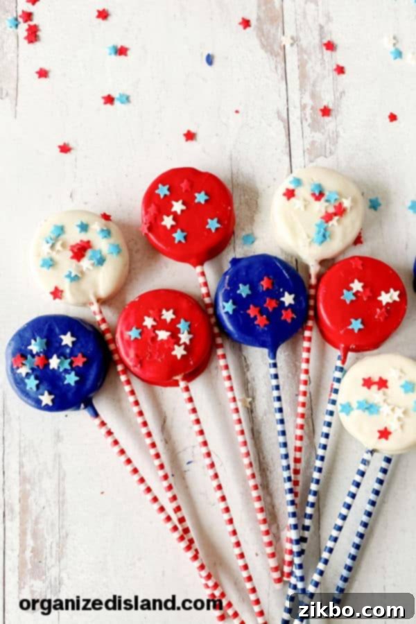 Red, White, and Blue Oreos, coated in patriotic candy and star sprinkles, a fun and easy no-bake treat for children.