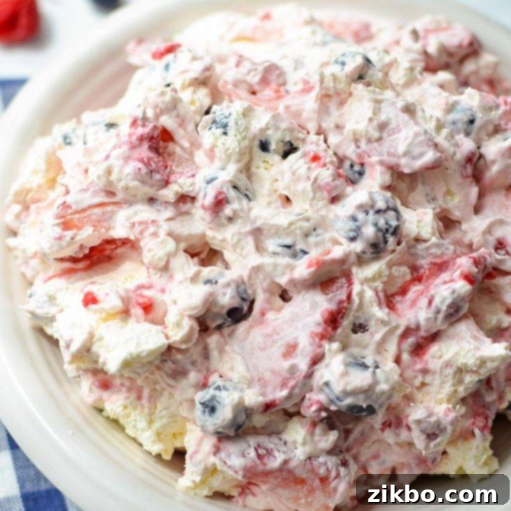 Creamy Red, White, and Blue Cheesecake Salad, a delightful mix of fresh berries and fluffy cheesecake, ideal for potlucks.