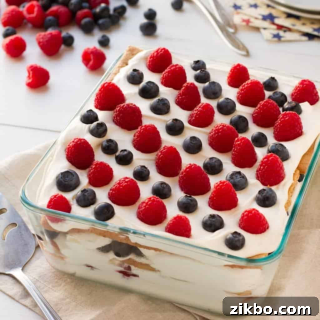 A classic 1930s No-Bake Berry Icebox Cake, featuring red, white, and blue layers, perfect for a refreshing patriotic dessert.