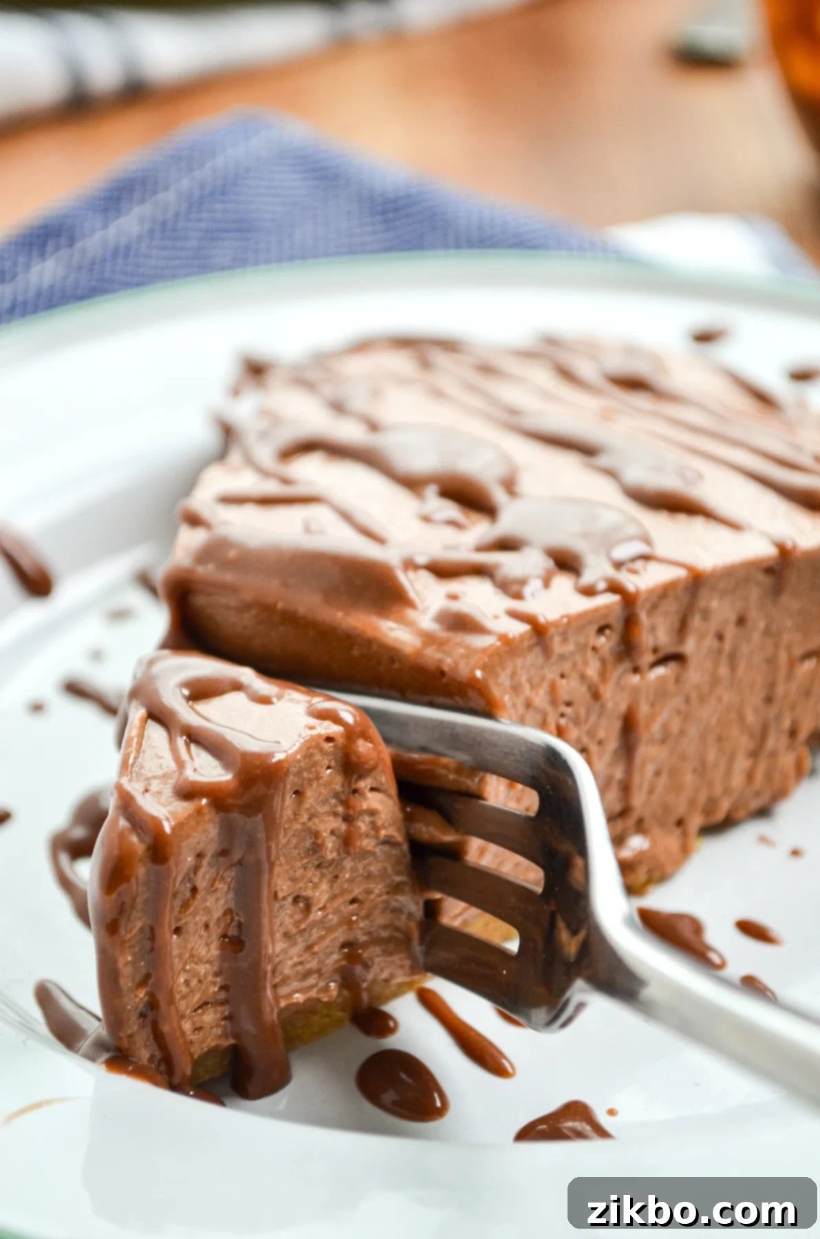 A fork sinking into a creamy slice of No Bake Nutella Pie