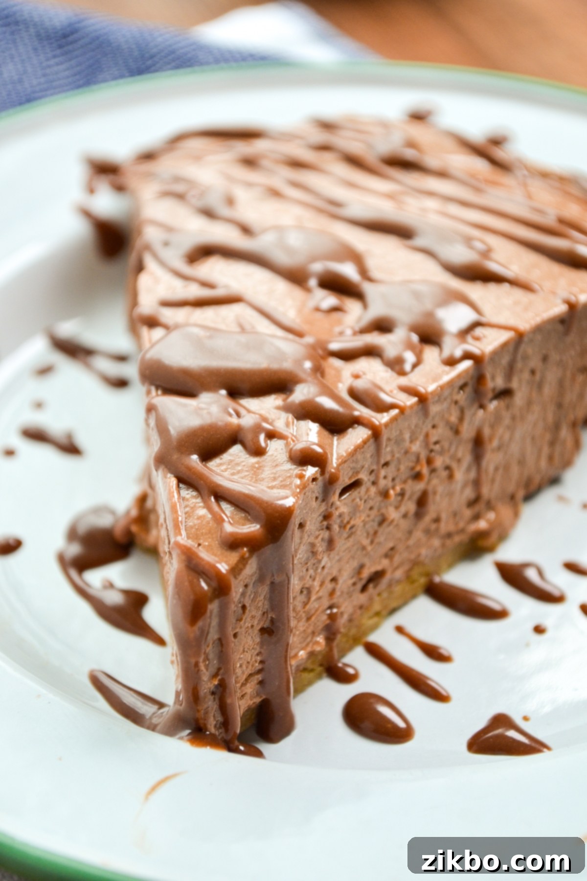 A slice of nutella pie topped with a nutella ganache.