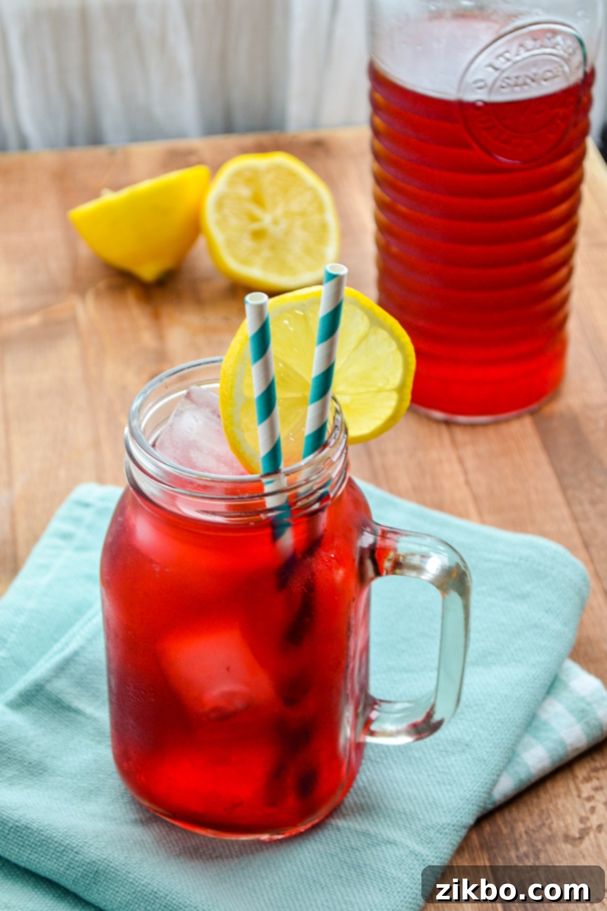 Close-up of a glass of Instant Pot Passion Tea Lemonade, garnished with fresh lemon wedges, ready to be enjoyed.