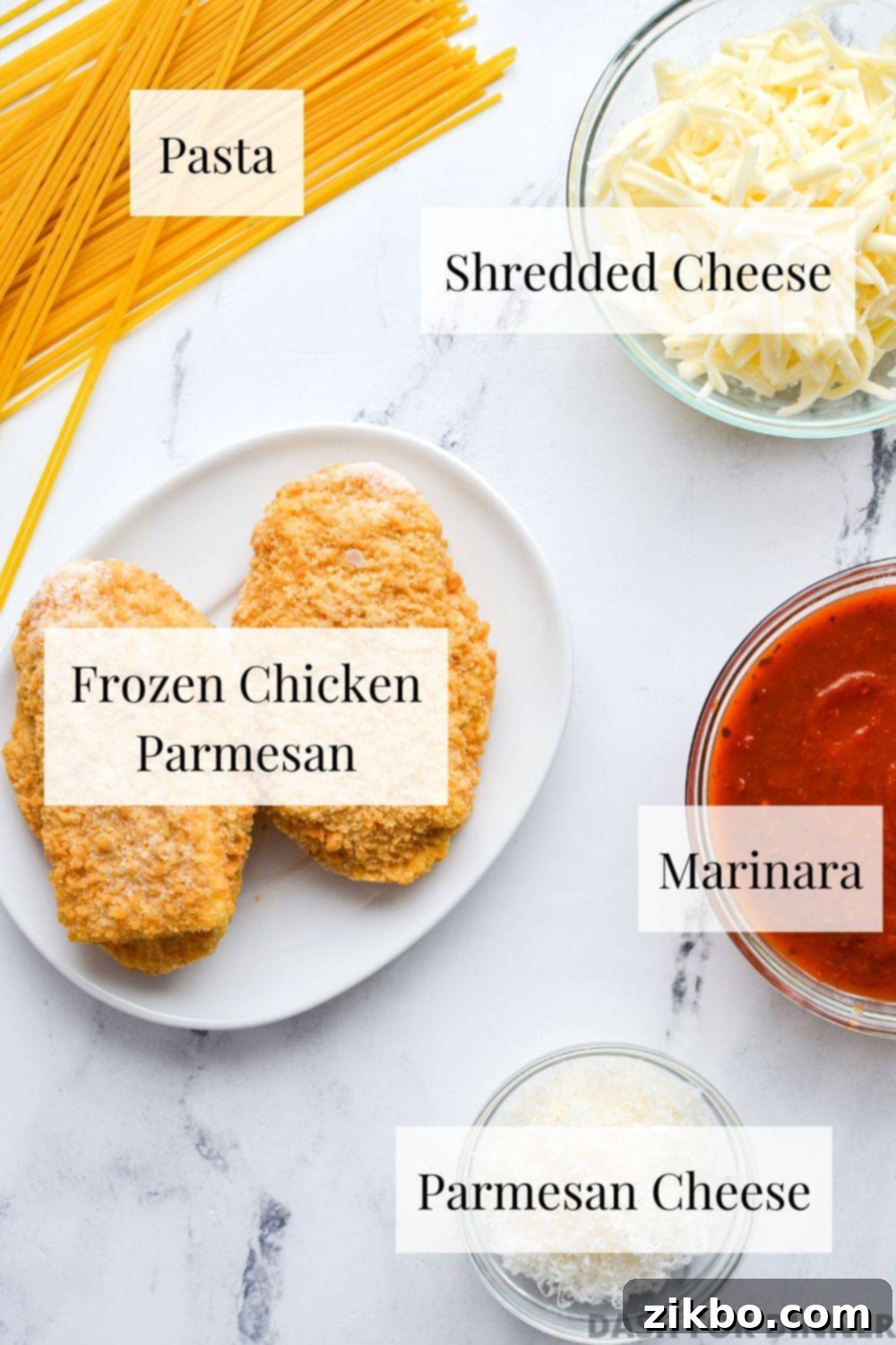 The ingredients needed to make frozen chicken parmesan - frozen chicken parmesan, pasta, shredded cheese, marinara, and parmesan cheese.