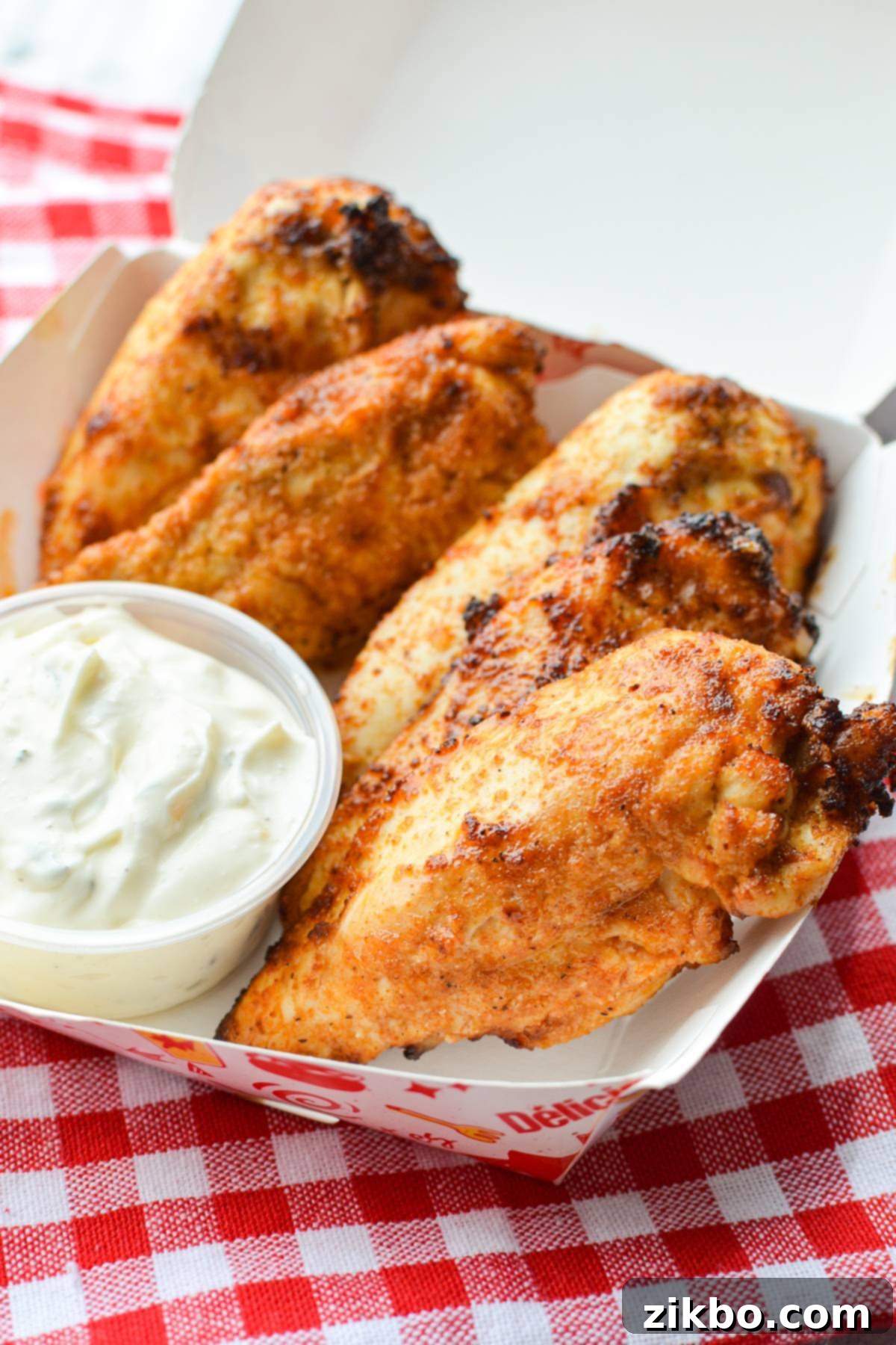 A take out box with plain chicken tenders inside.