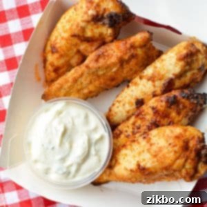 A small takeout box with plain chicken tenders and ranch dip.