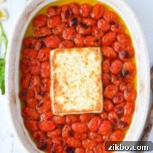 A baking dish with blistered cherry tomatoes and toasty feta cheese.
