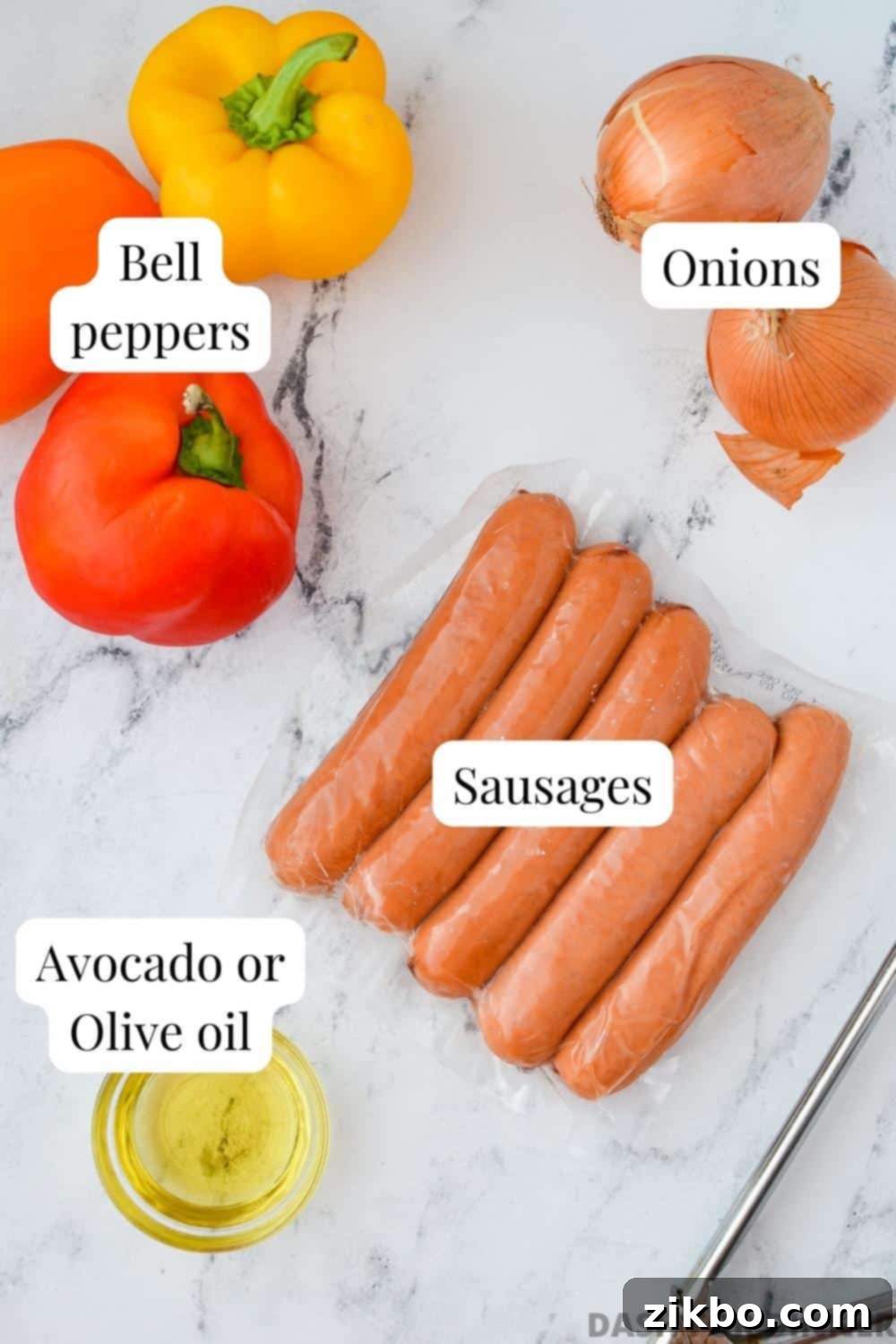 The ingredients needed to make sausage and peppers: smoked sausage, bell peppers, onions, and oil, laid out on a table.