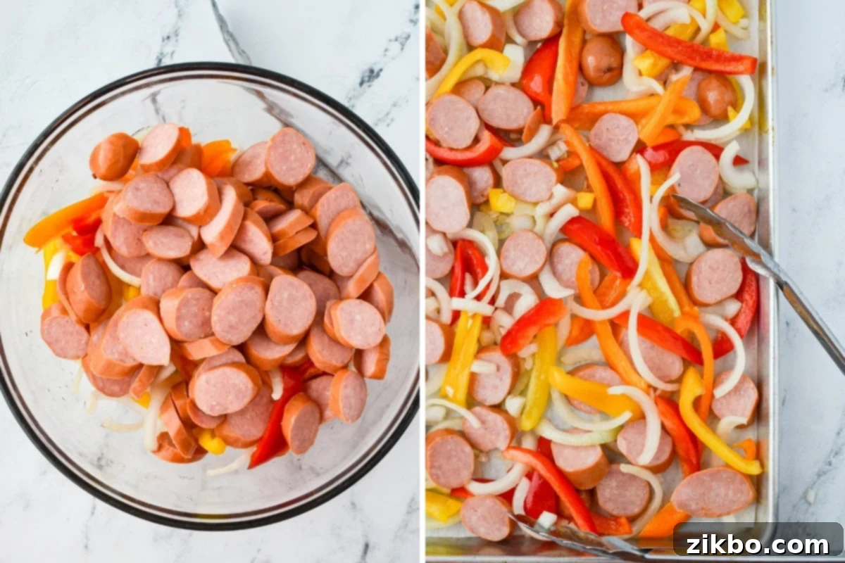 A bowl filled with sliced smoked sausage, bell pepper strips, and onion slices, ready to be spread on a sheet pan.