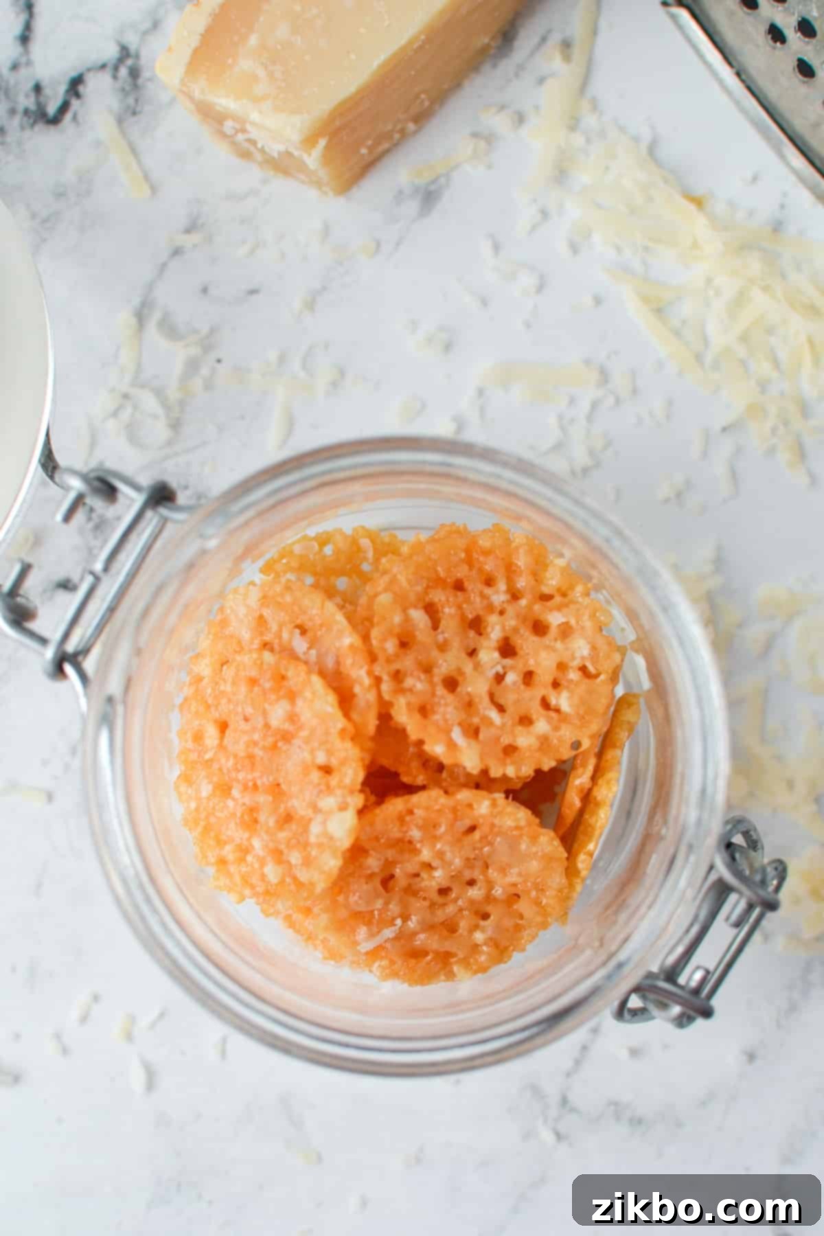 Savory Parmesan Snaps 2 A small jar with cheese crisps inside.
