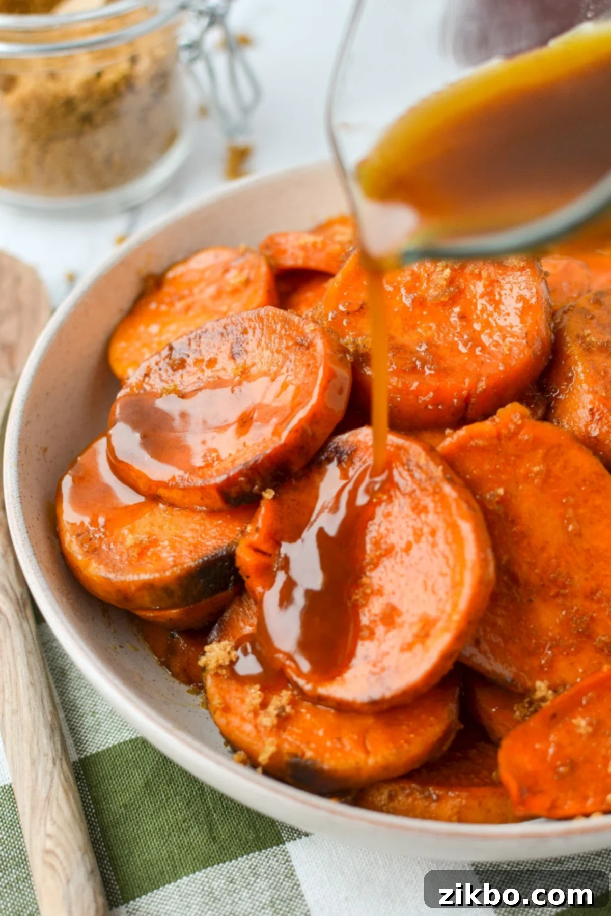 Pouring a glaze on sweet potato rounds.