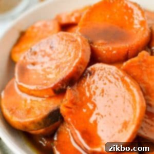 A bowl with sweet potato slices that have been covered in a glaze.