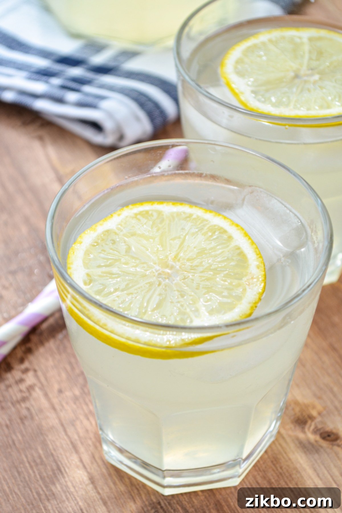 Two vibrant glasses of Instant Pot lemonade, garnished with a lemon slice, ready to be served over ice.
