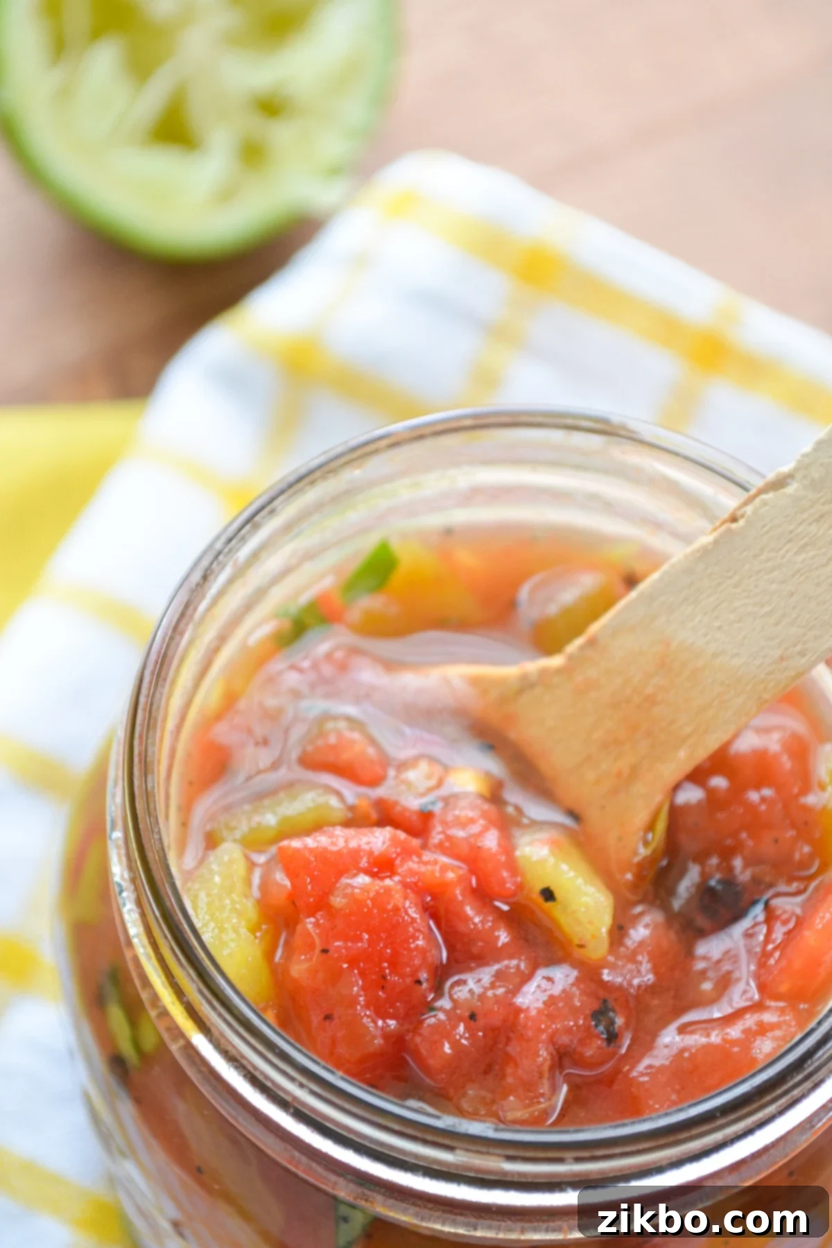 A homemade substitute for Rotel tomatoes and chilies in a glass jar.