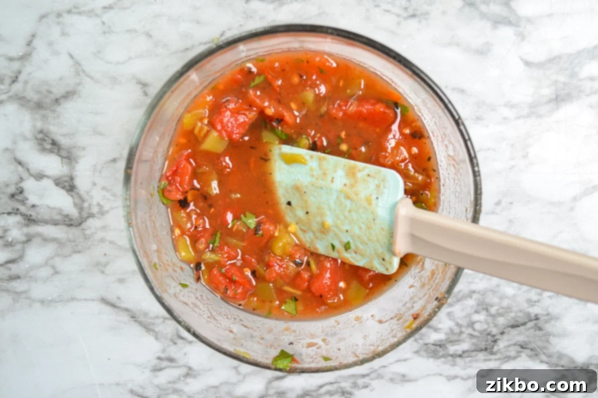A bowl of diced tomatoes and green chilies, mixed together to be used as a Rotel substitute.