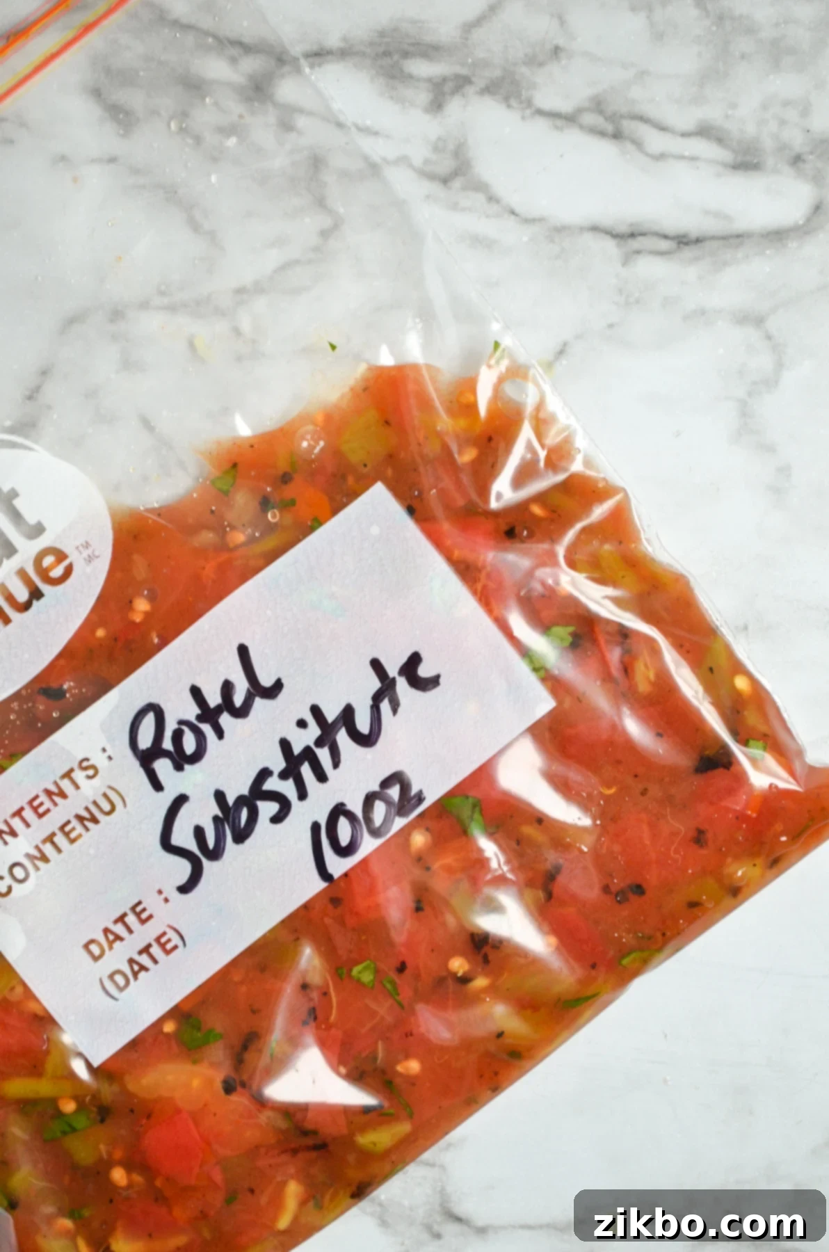 A freezer baggie with green chilies and tomatoes inside. Labeled: "Rotel substitute"