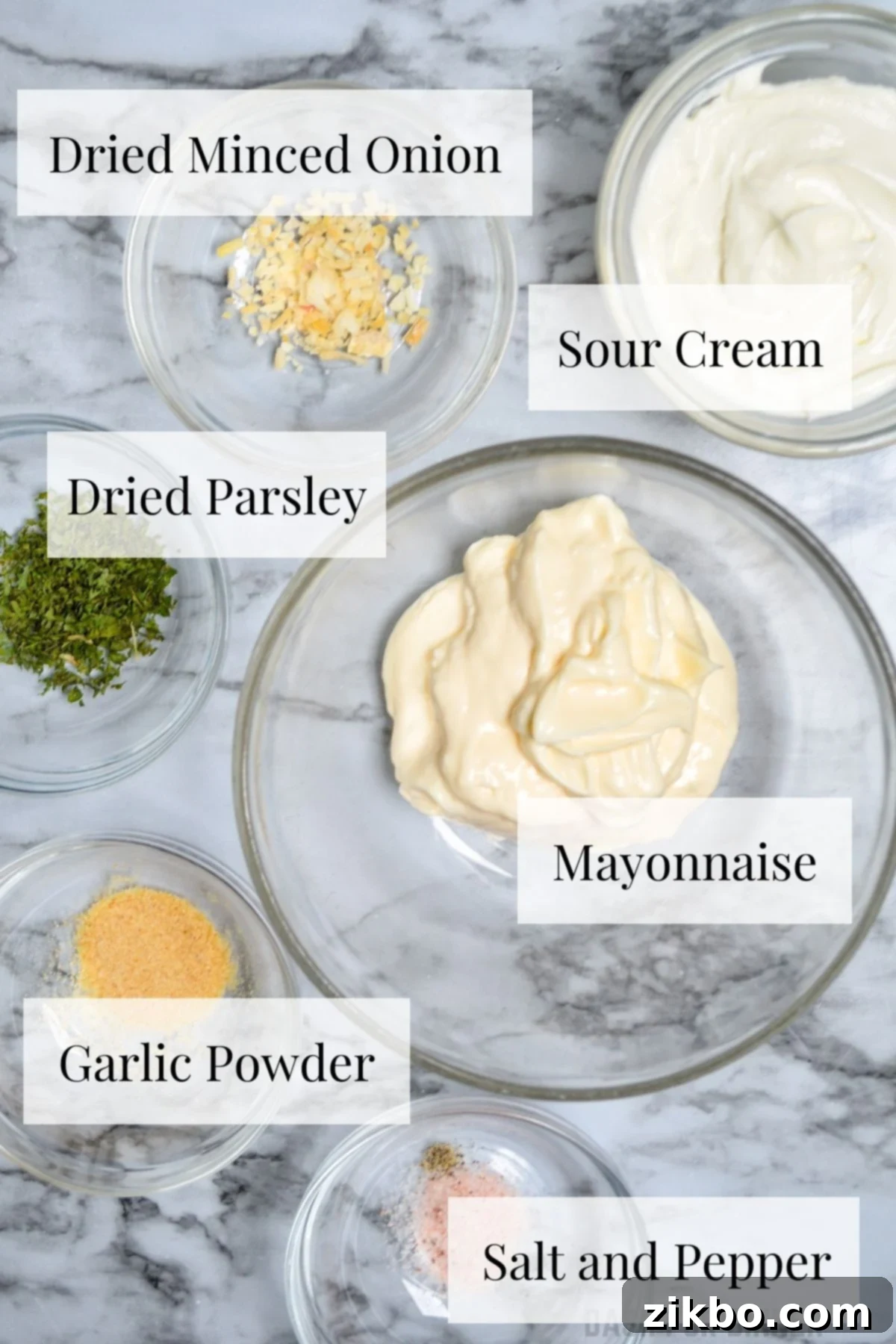 The ingredients needed to make ranch dip: mayonnaise, sour cream, dried minced onion, dried parsley, garlic powder, salt, and pepper.