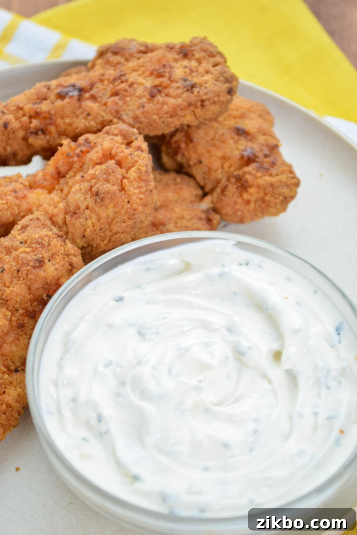 A serving of fried chicken tenders with ranch dip, showcasing the perfect pairing.