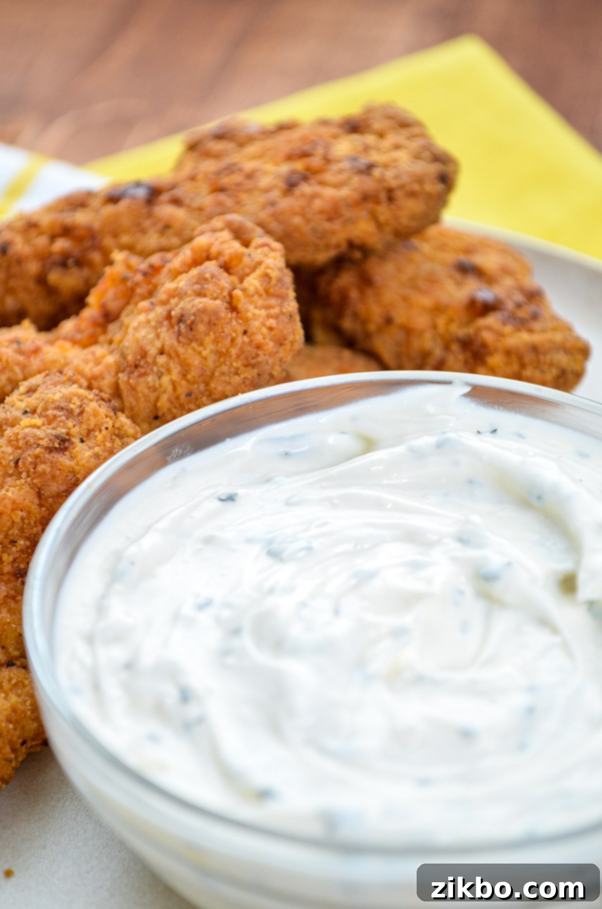 A serving of fried chicken tenders, with ranch dipping sauce on the side, highlighting its versatility.