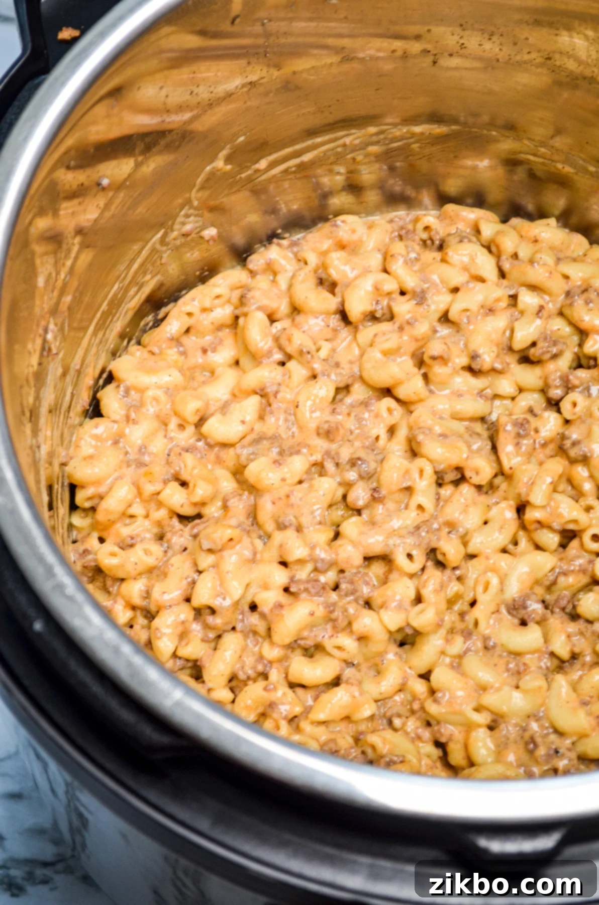 A serving of homemade Hamburger Helper in a bowl, garnished with fresh herbs.