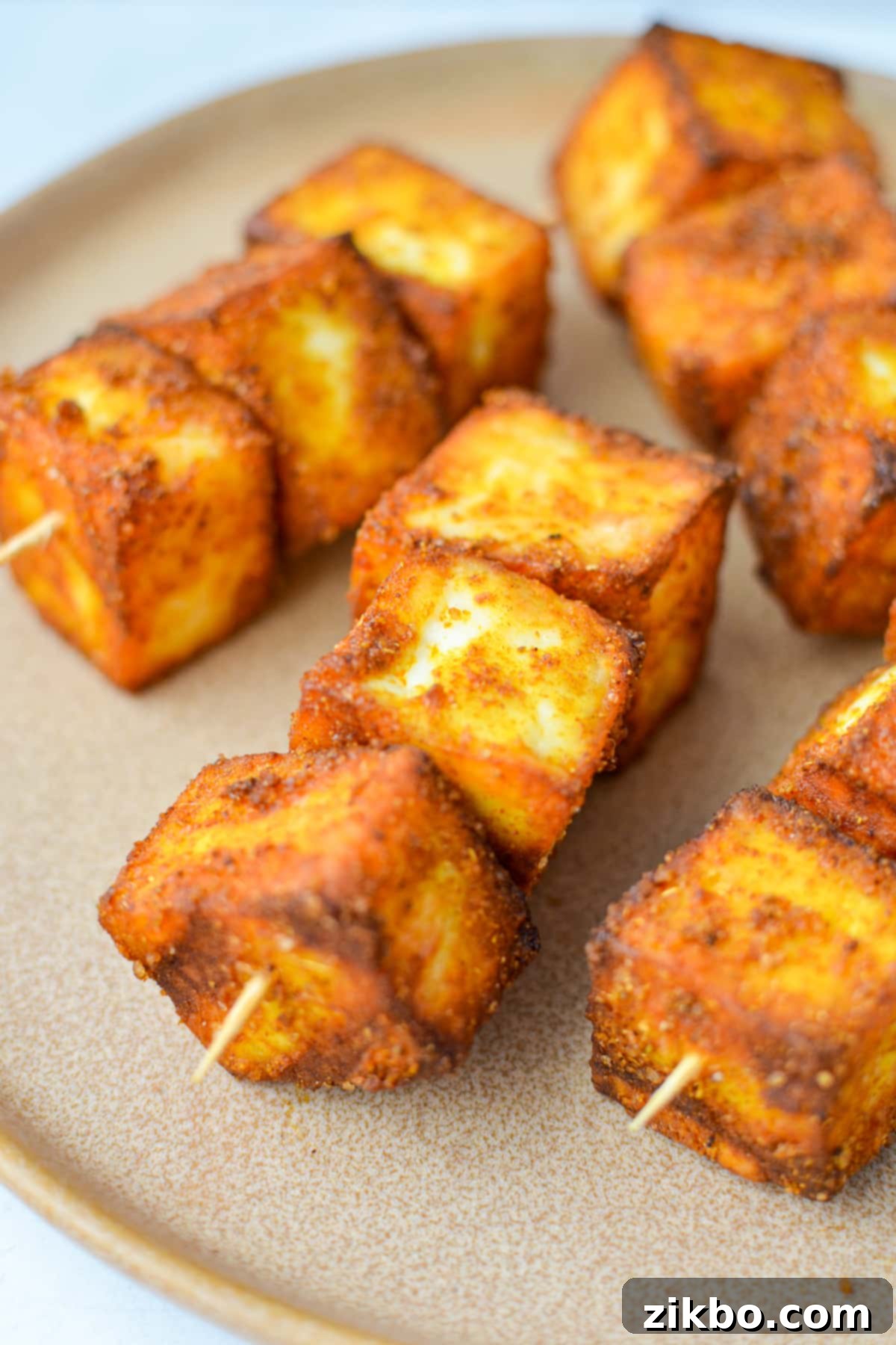 Quick Air Fryer Paneer 6 Paneer skewered onto toothpicks.