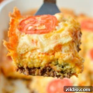 Lifting a square of casserole from a baking dish.