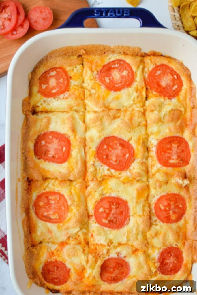 A baking dish with egg and cheese casserole cut into servings.