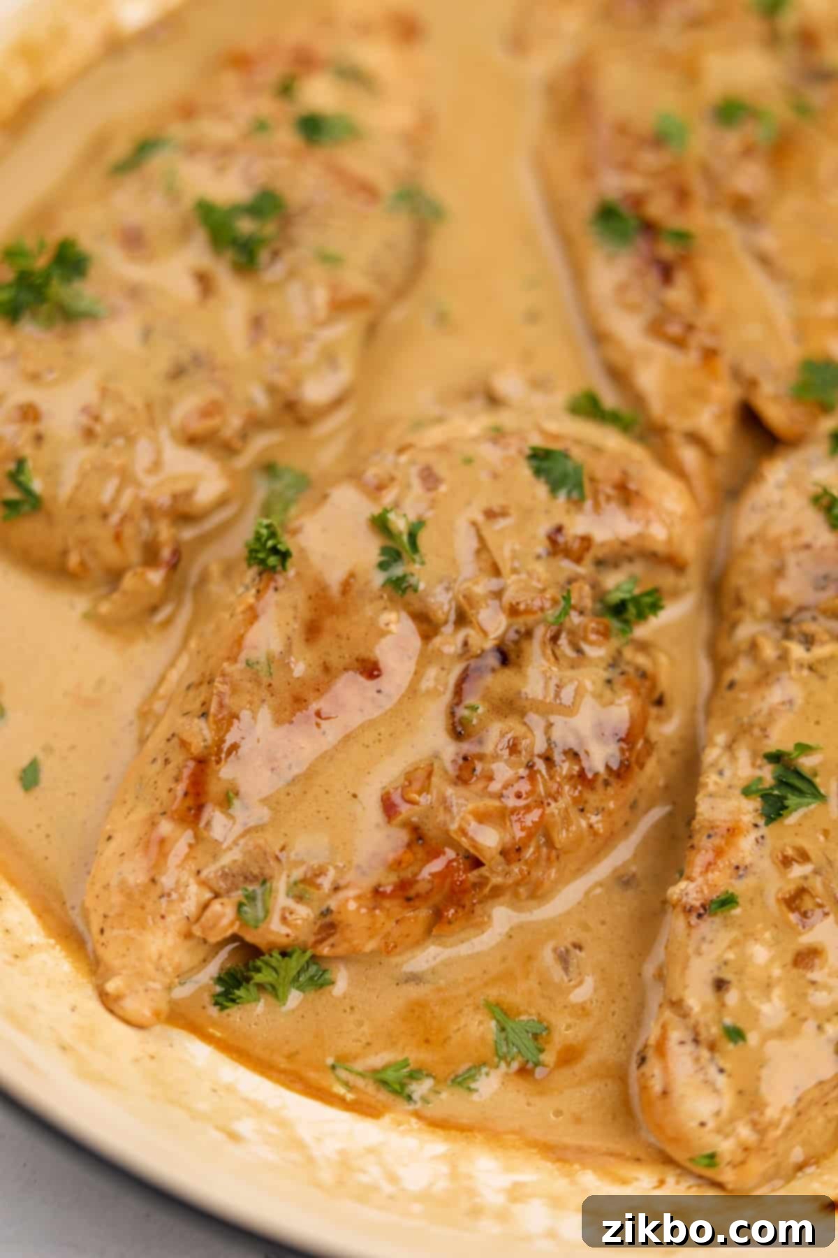 Beautifully cooked Chicken Diane garnished with fresh parsley, highlighting the rich, creamy texture of the sauce.
