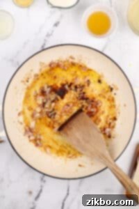 Cooking a shallot in a skillet with oil and butter.