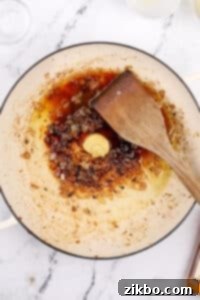 Adding dijon, brandy, and lemon juice to a skillet to make a pan sauce.
