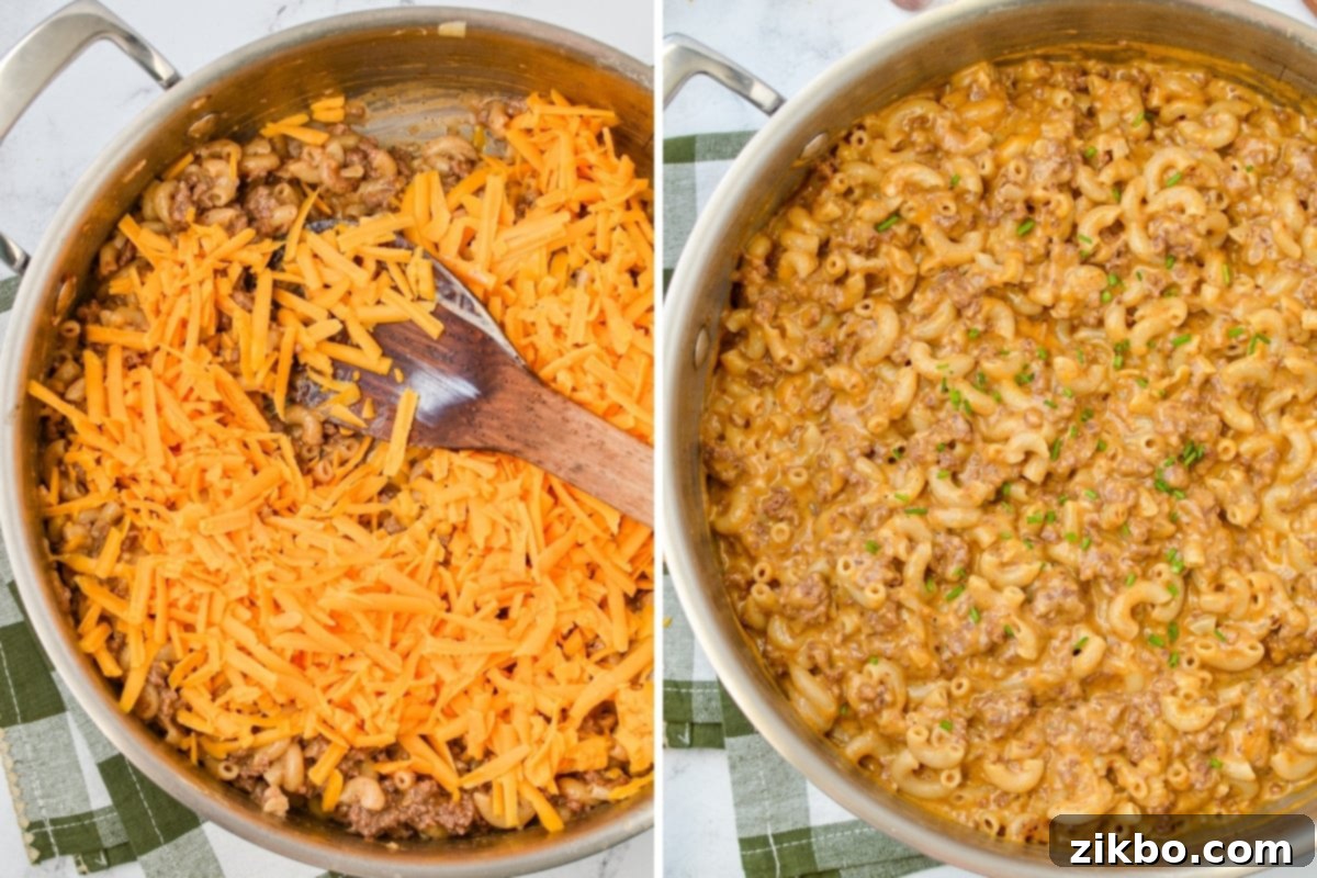 Adding shredded cheese to a skillet with ground beef and macaroni, stirring to melt.