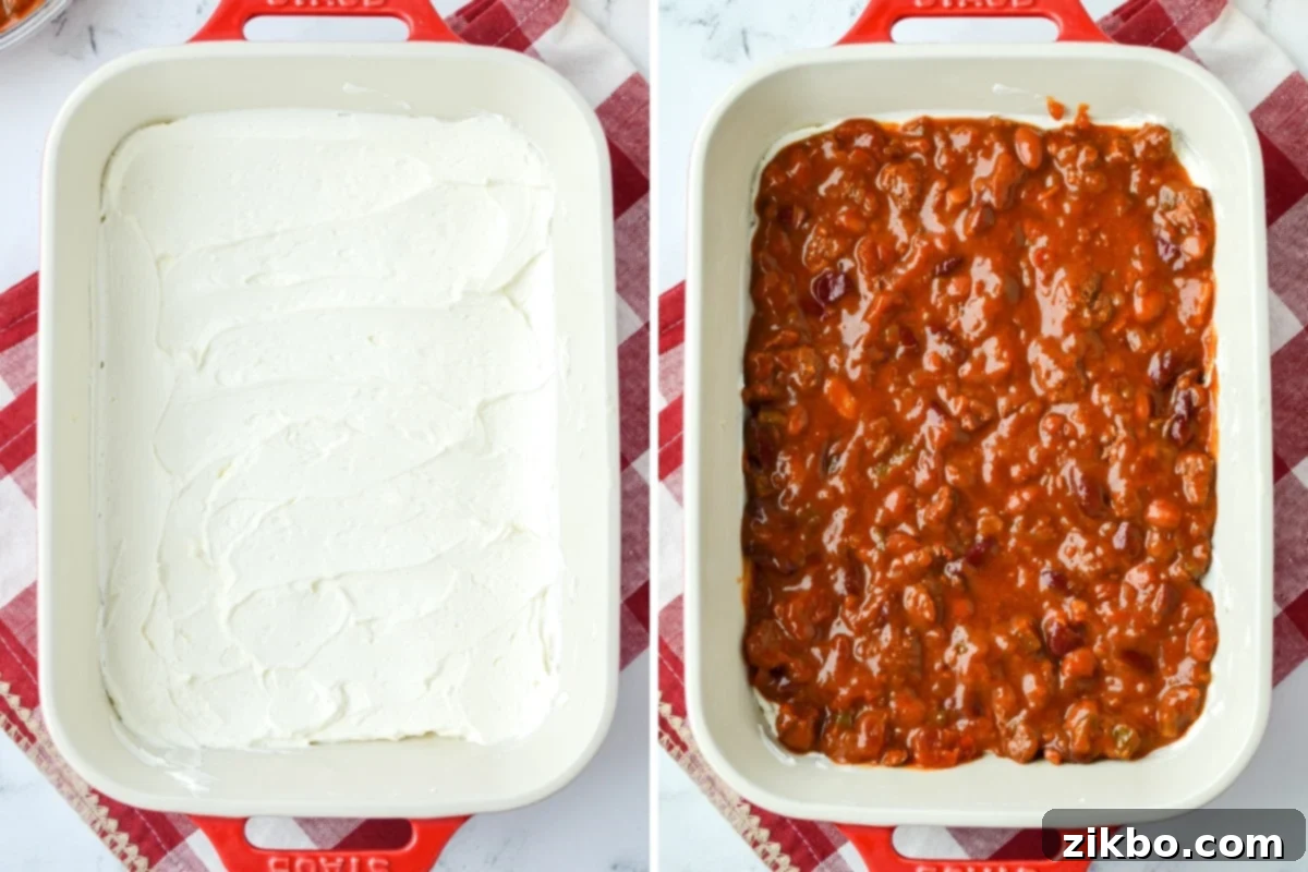 Easy Chili Cheese Dip 5 A baking dish spread with a layer of sour cream and cream cheese, then topped with chili evenly.