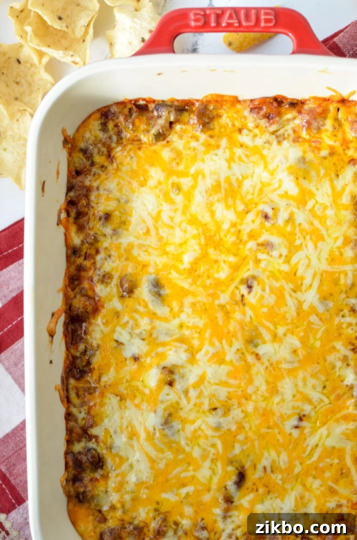 Easy Chili Cheese Dip 8 A baking dish filled with a cheesy chili cheese dip, perfectly golden and bubbly.