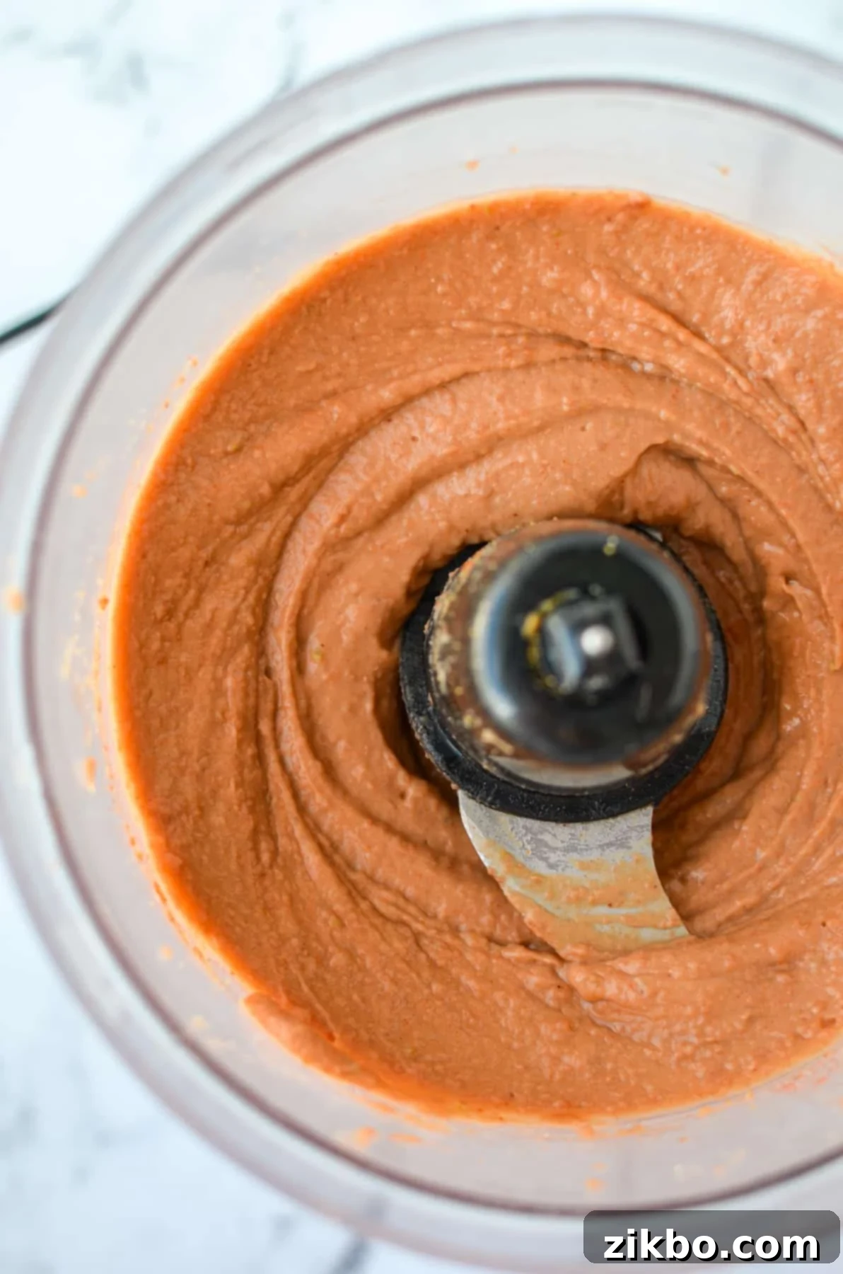 Ultimate Homemade Fritos Bean Dip 5 A food processor containing the perfectly blended, smooth, and creamy bean dip.