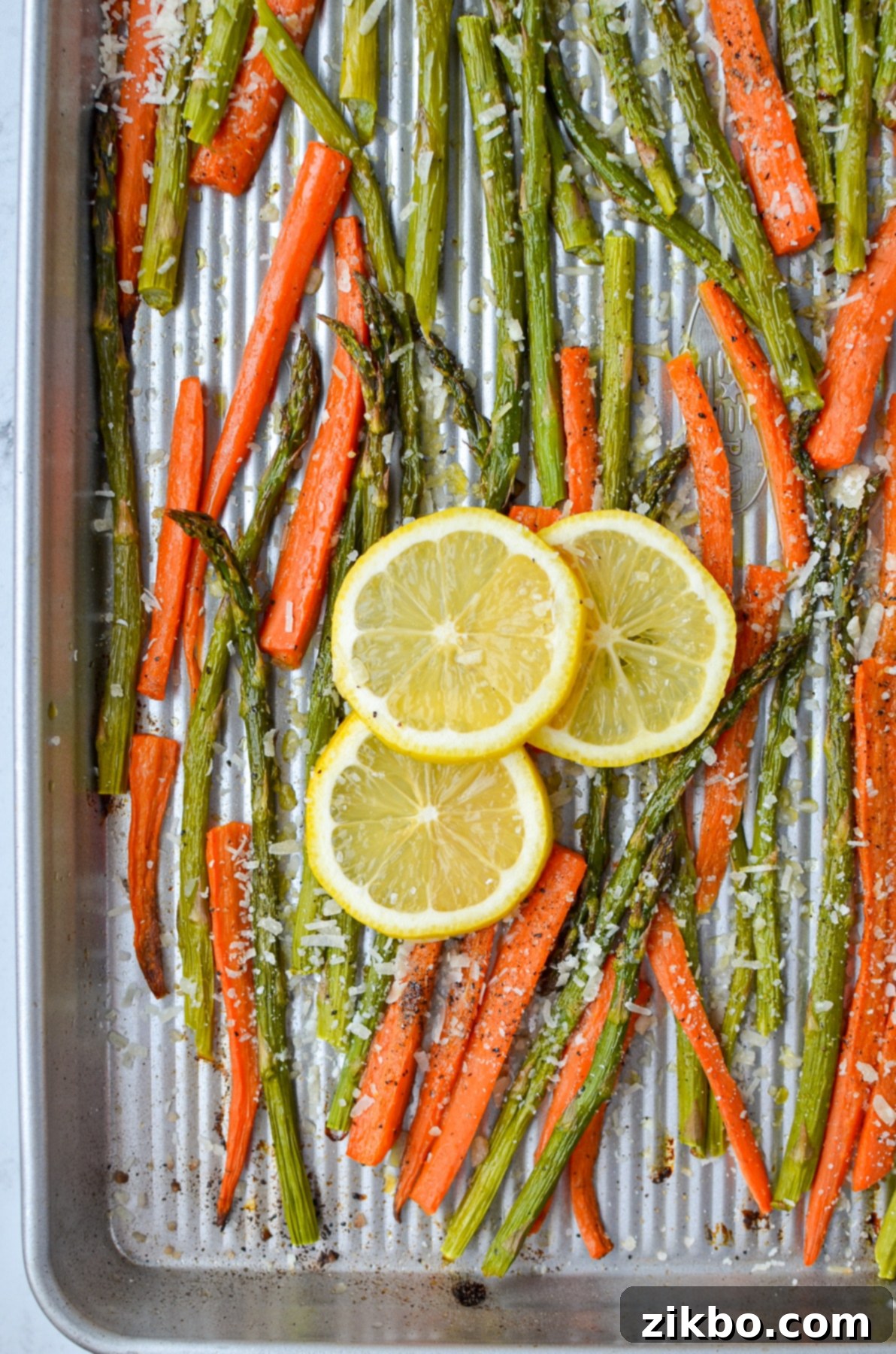 A sheet pan of colorful roasted veggies, glistening with olive oil and fresh lemon juice, ready to be served.