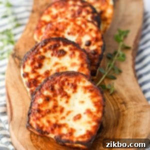 A wooden board with perfectly air-fried slices of halloumi cheese, ready to be served.