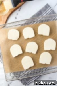 An air fryer tray with halloumi cheese slices arranged neatly.