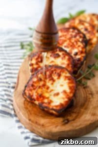Drizzling honey on freshly fried halloumi cheese for serving.