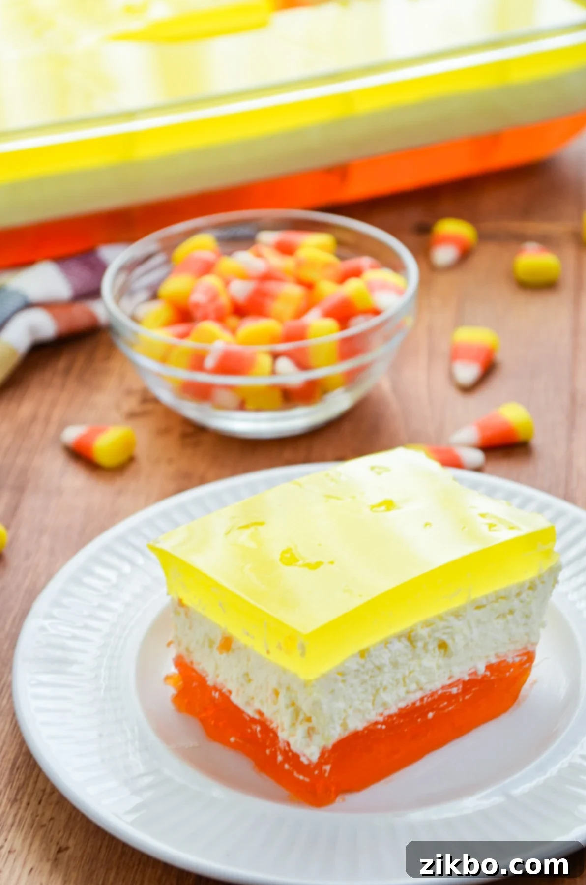A slice of our 3-layered Halloween Jell-O, with scattered candy corns for a festive touch.