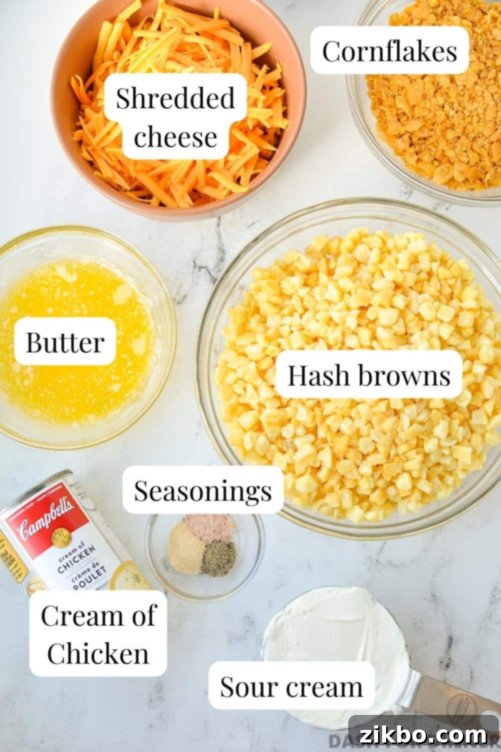 The ingredients needed to make hash brown casserole: hash browns, cheese, butter, etc.