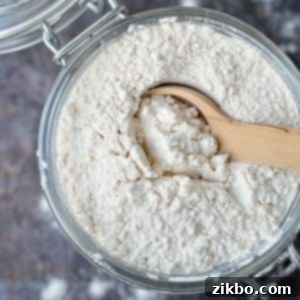 A small jar of homemade self-rising flour on a wooden surface.