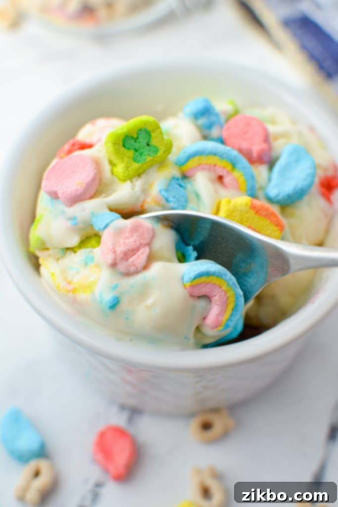 A spoon taking a spoonful of smooth, homemade cereal milk ice cream, showcasing its creamy texture.