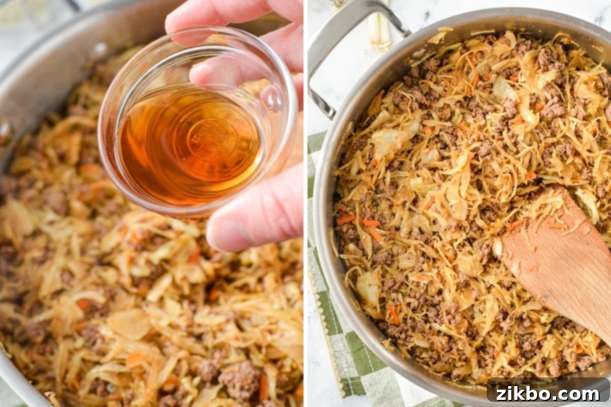 Stirring toasted sesame oil into the cooked egg roll filling in a skillet, enhancing its aromatic flavor.