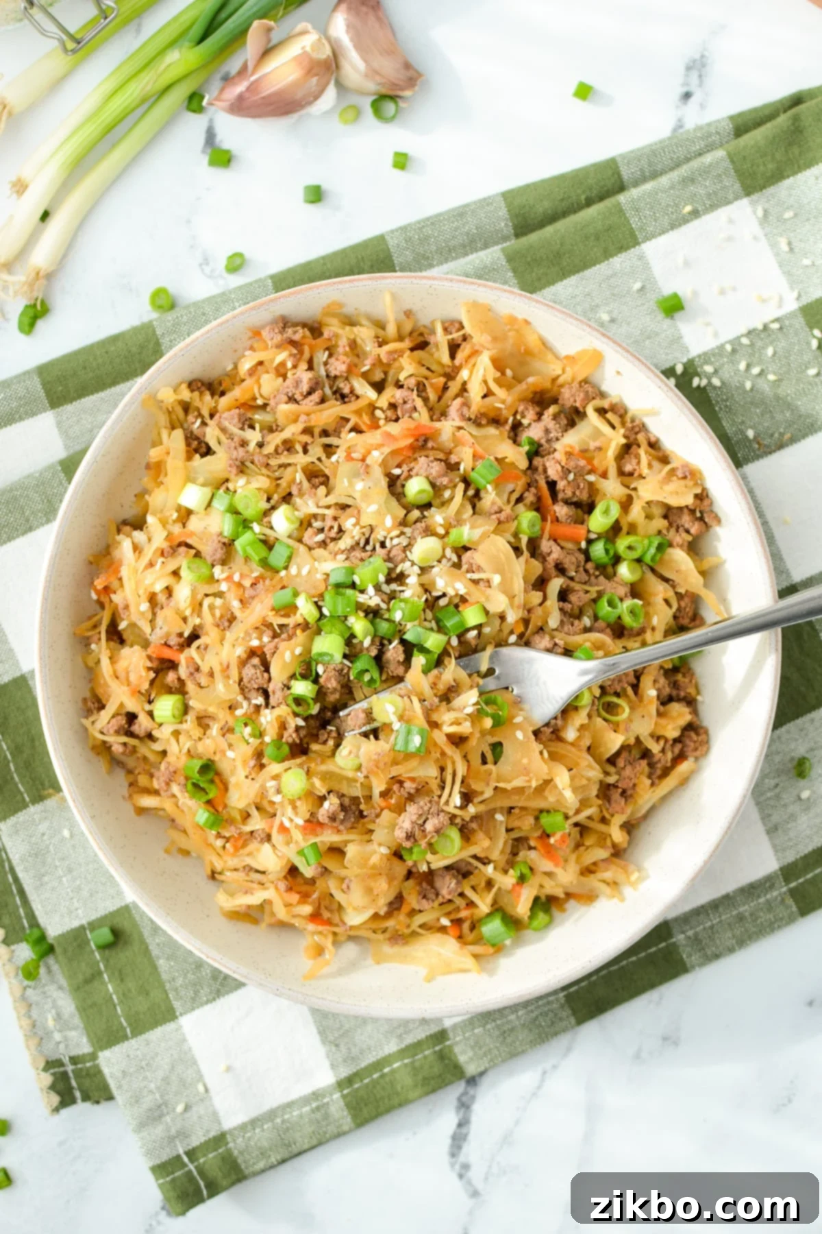 A perfectly portioned bowl filled with savory cabbage and ground beef stir-fry, garnished and ready to eat.