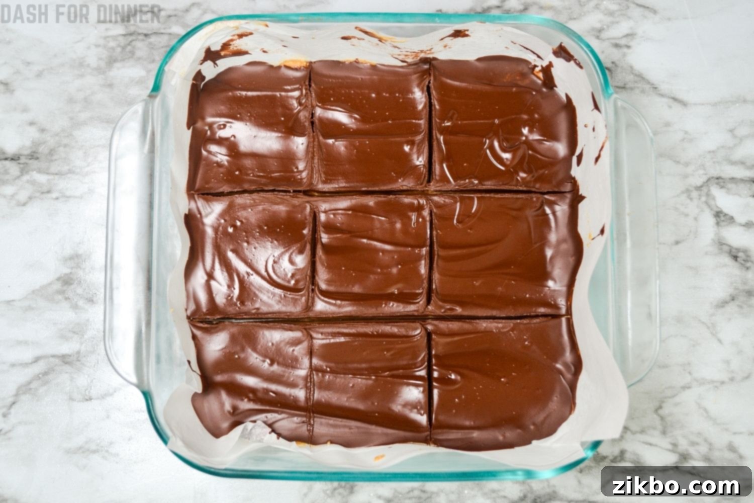 No bake peanut butter bars cut into 9 perfect squares, showcasing the clean layers.