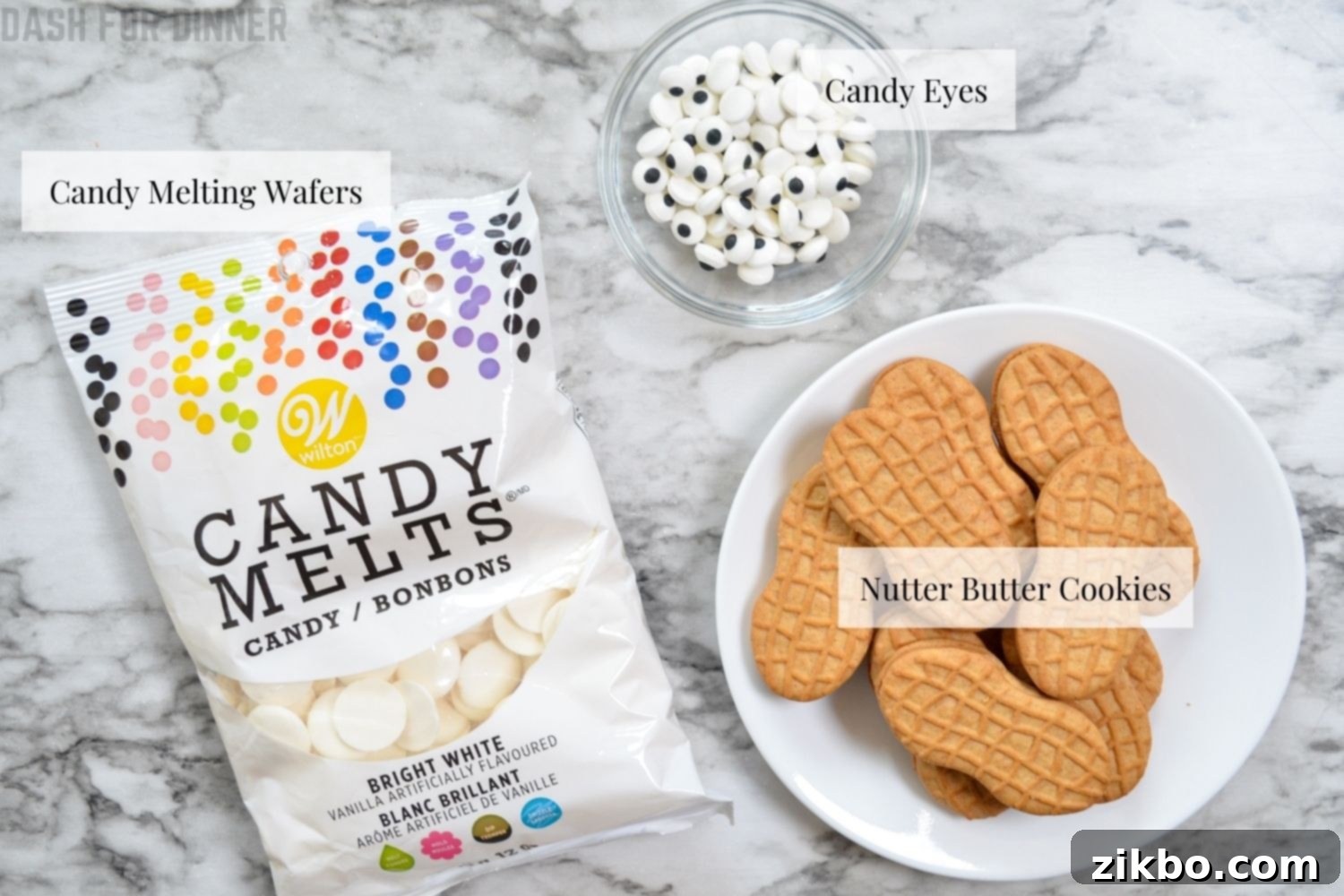 The three main ingredients laid out: Nutter Butter cookies, white candy melts, and candy eyes.