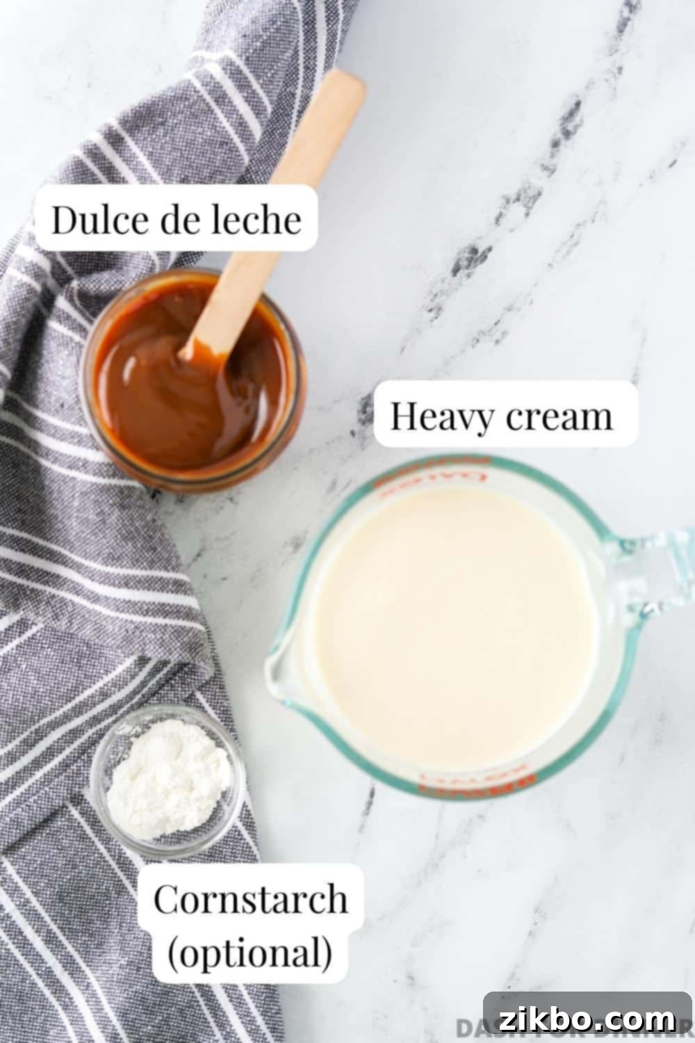 The simple ingredients needed to make homemade dulce de leche mousse: a jar of dulce de leche, heavy cream, and an optional bag of cornstarch.